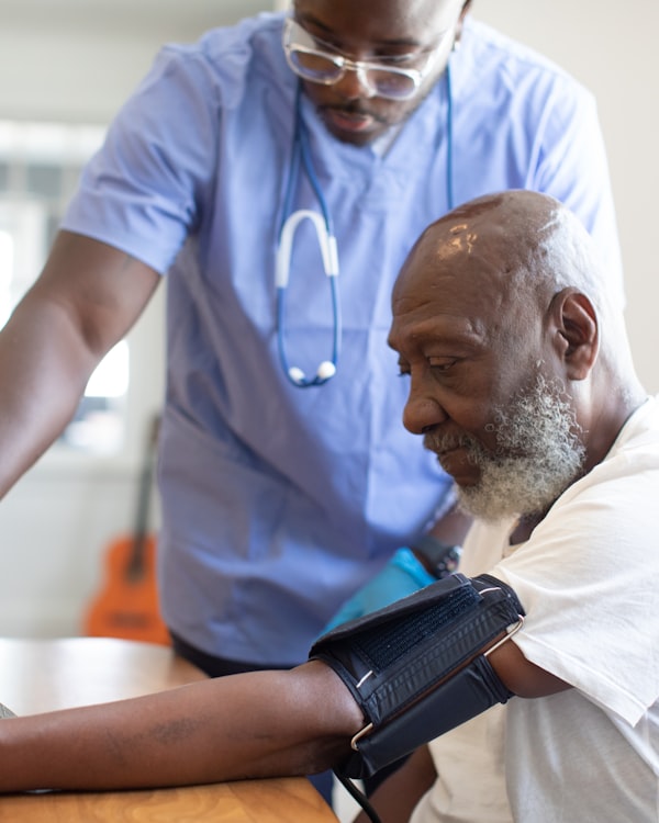 A doctor taking a patient's blood pressure